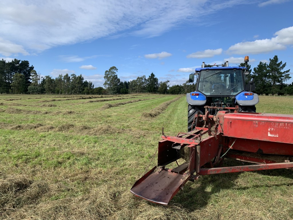 baler making fresh hay bales